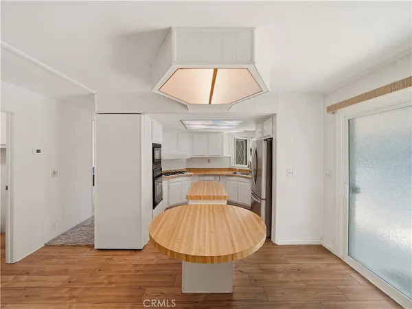 a view of a kitchen cabinets and wooden floor