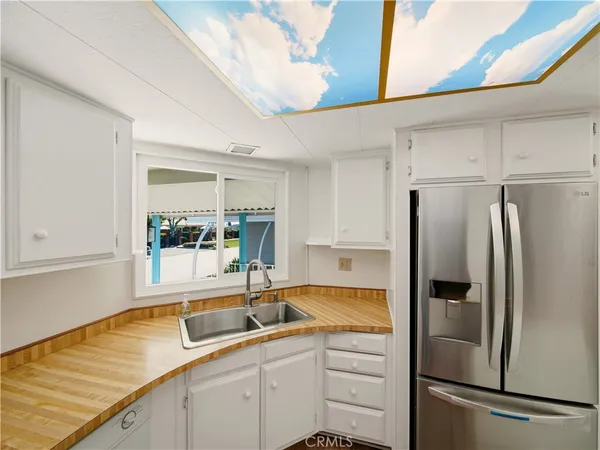 a kitchen with a sink and refrigerator