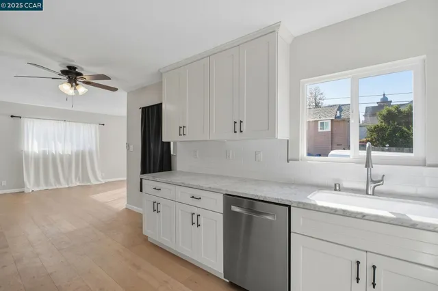 a kitchen with a sink appliances and cabinets