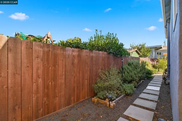 a view of a garden with wooden fence