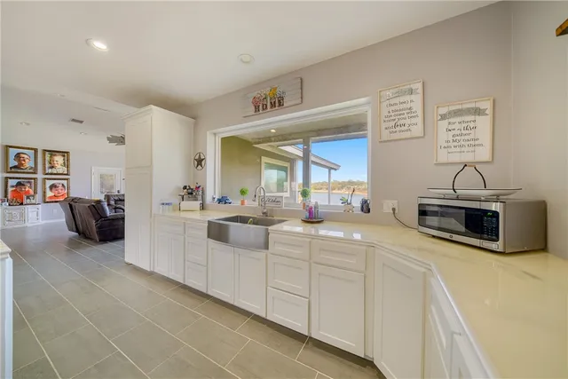 a large white kitchen with cabinets