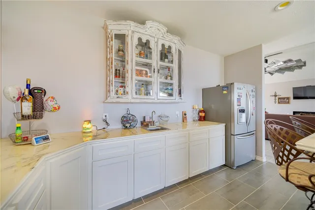 a kitchen with a sink a refrigerator and a stove top oven
