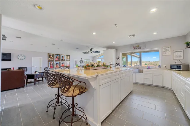 a kitchen with stainless steel appliances kitchen island granite countertop a sink and cabinets