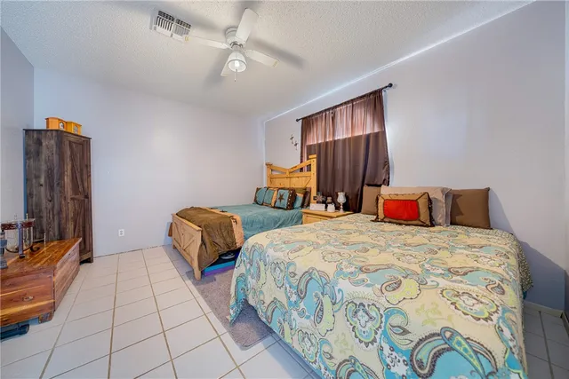 a bedroom with two beds and a chandelier