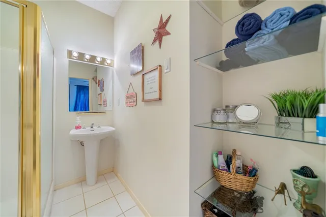 a bathroom with a sink mirror and vanity