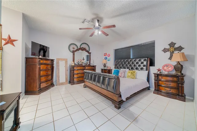 a bedroom with furniture and a chandelier