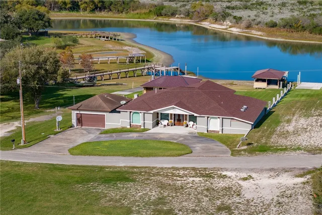 an aerial view of a house with a lake view