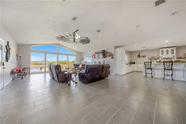 a living room with furniture and kitchen view