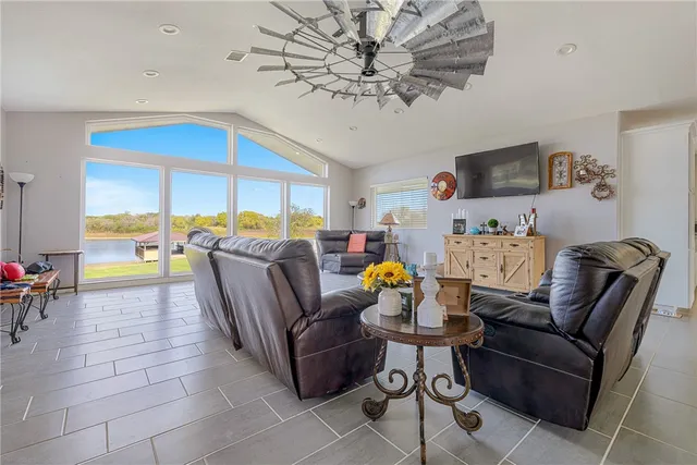 a living room with patio furniture and a floor to ceiling window