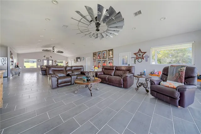 a living room with furniture and chandelier