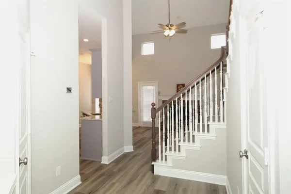 a view of entryway and hall with wooden floor