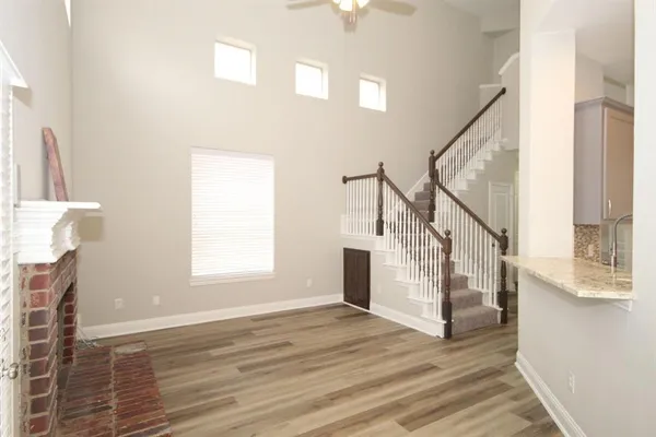 a view of entryway and hall with wooden floor
