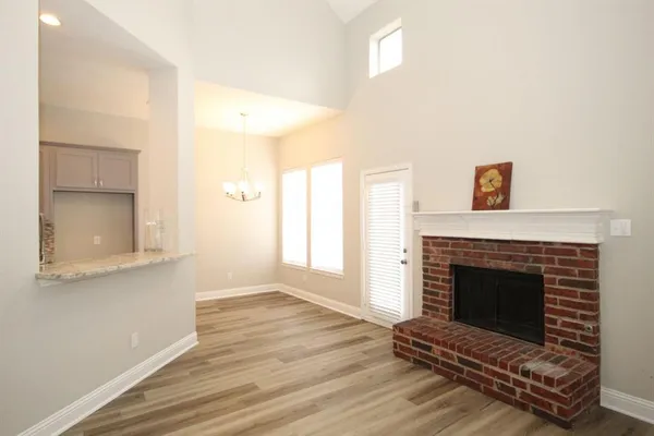 a living room with a fireplace and wooden floor