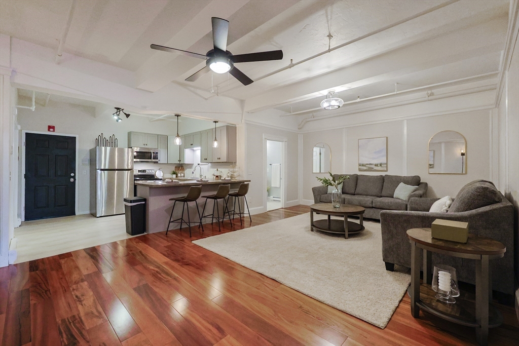 a living room with furniture and kitchen view