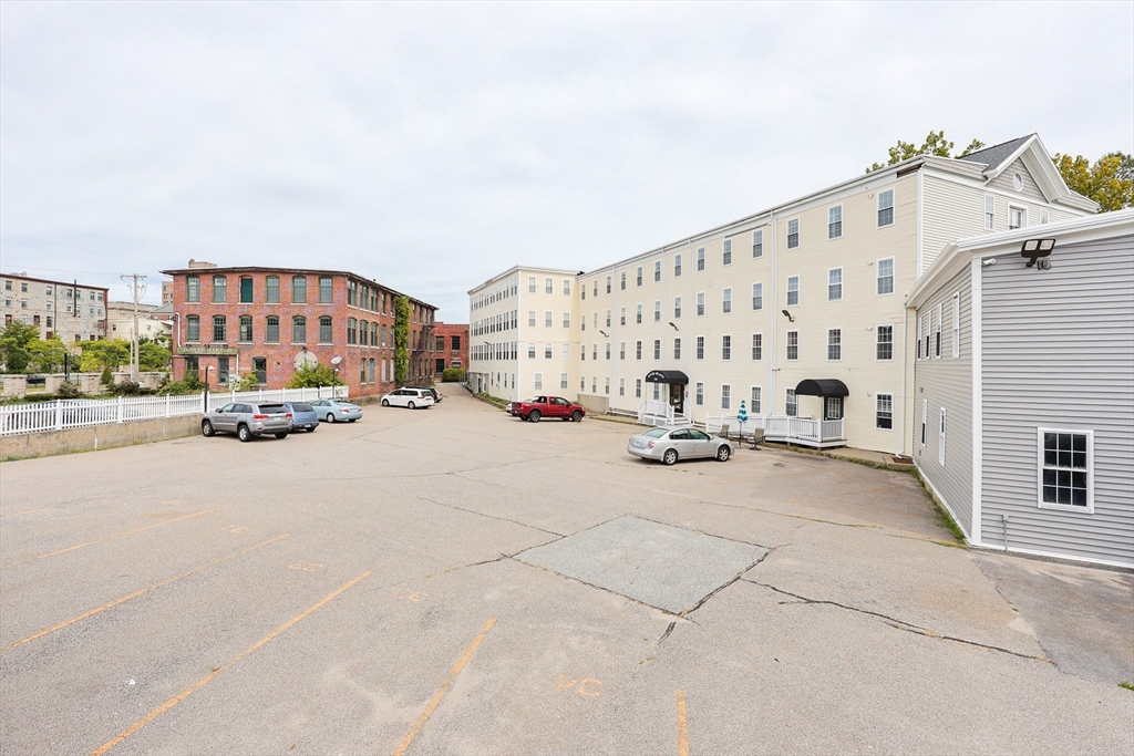 148 Bernon Street, Unit 19 Woonsocket, RI 02895 - Photo 19 of 20 a view of building with parking