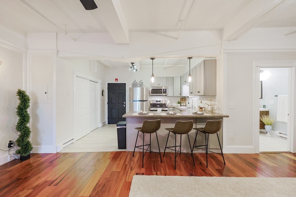 148 Bernon Street, Unit 19 Woonsocket, RI 02895 - Photo 3 of 20 a view of a dining room with furniture and wooden floor