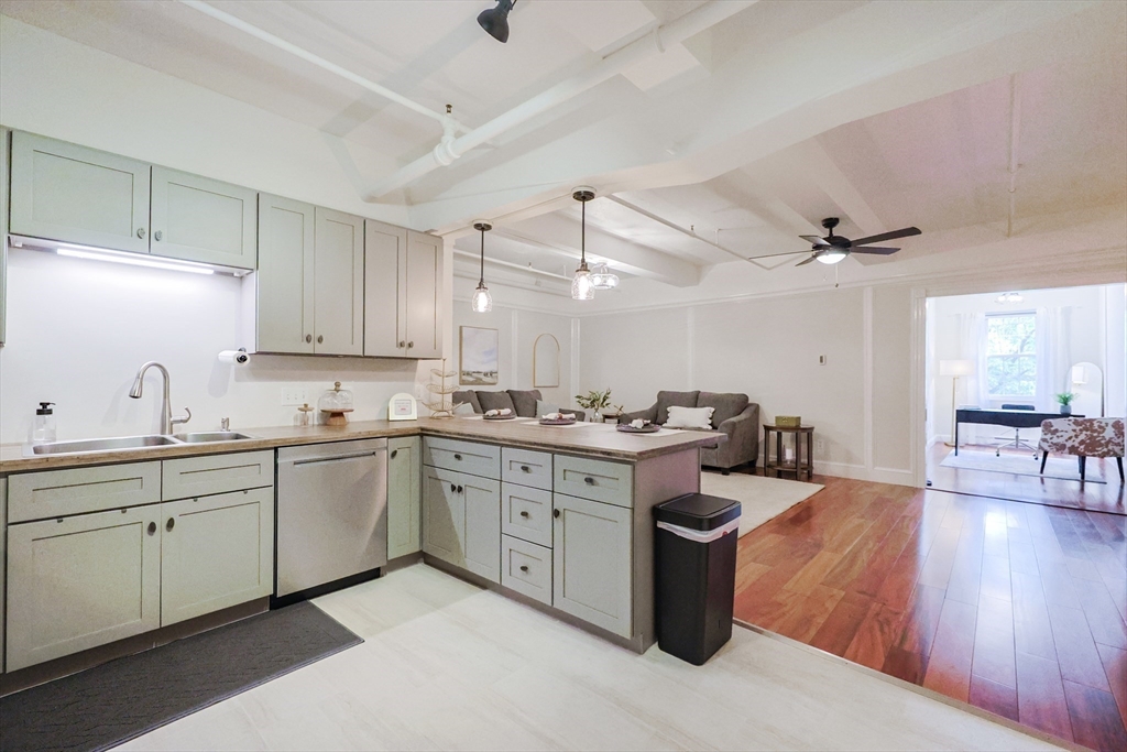 148 Bernon Street, Unit 19 Woonsocket, RI 02895 - Photo 6 of 20 a kitchen with sink cabinets and stove