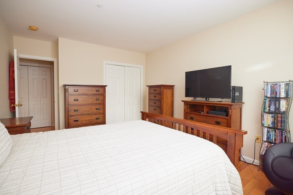 974 Main Street, Unit 34 Wakefield, MA 01880 - Photo 11 of 15 a bedroom with a bed and a flat screen tv