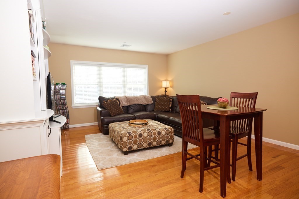974 Main Street, Unit 34 Wakefield, MA 01880 - Photo 2 of 15 a living room with furniture and a wooden floor