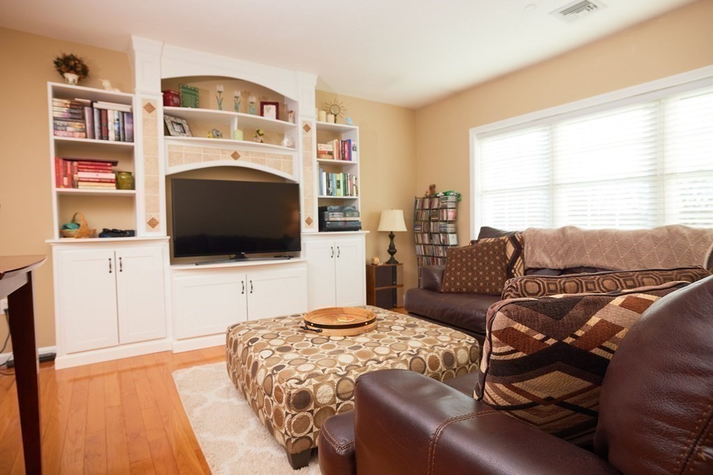 974 Main Street, Unit 34 Wakefield, MA 01880 - Photo 3 of 15 a living room with couches a flat screen tv and a fireplace