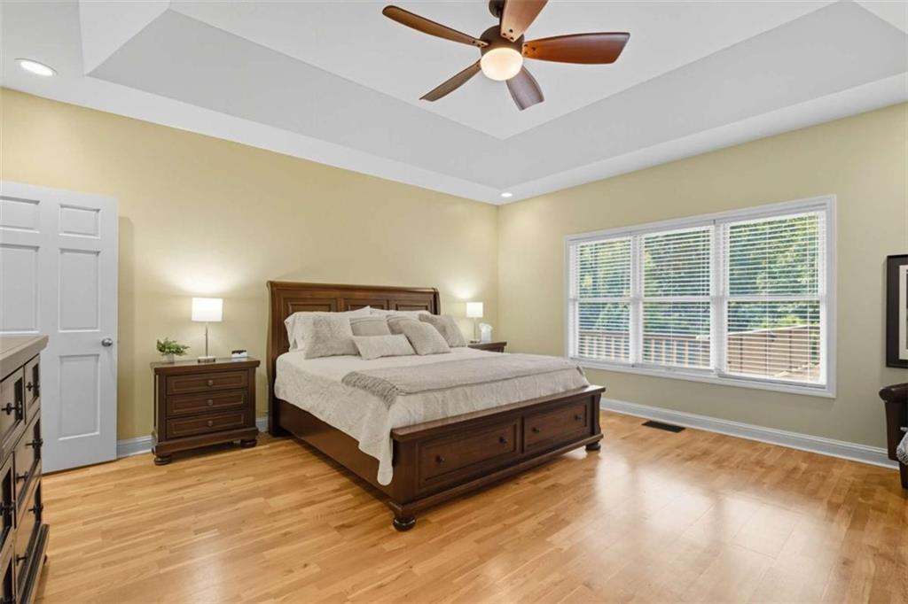 1091 Echota Road Clarkesville, GA 30523 - Photo 16 of 89 a spacious bedroom with a large bed and a chandelier