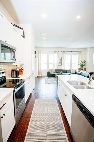 a large white kitchen with a large window