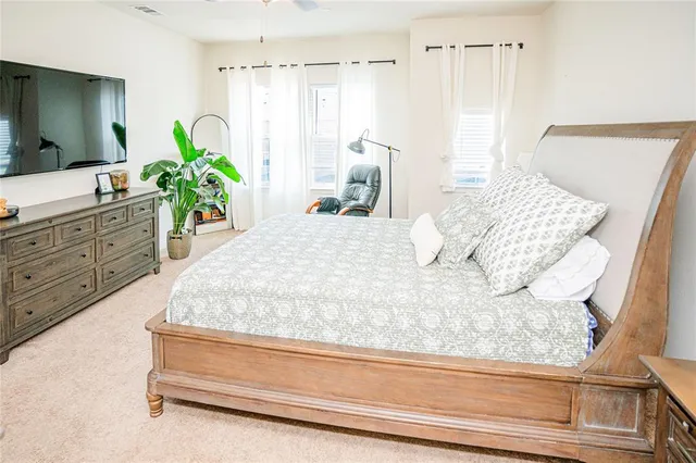 a bed sitting in a bedroom next to a window