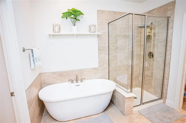 a view of living room with a bed a couch and a potted plant