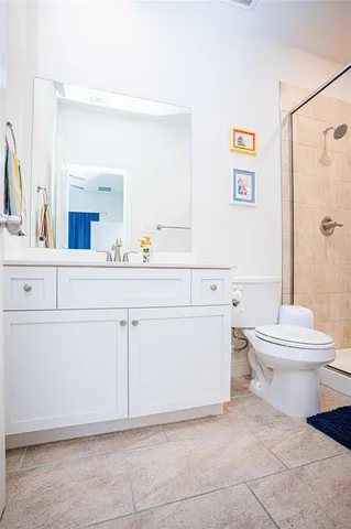 a bathroom with a shower a toilet and a shower