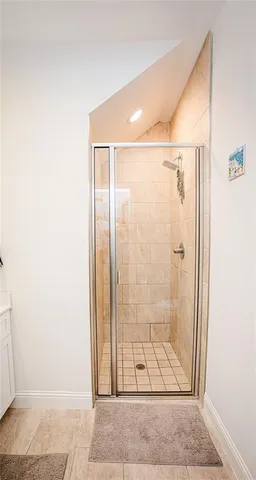 a bathroom with a shower and closet