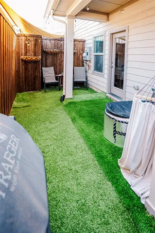 a view of a backyard with chairs and a small yard