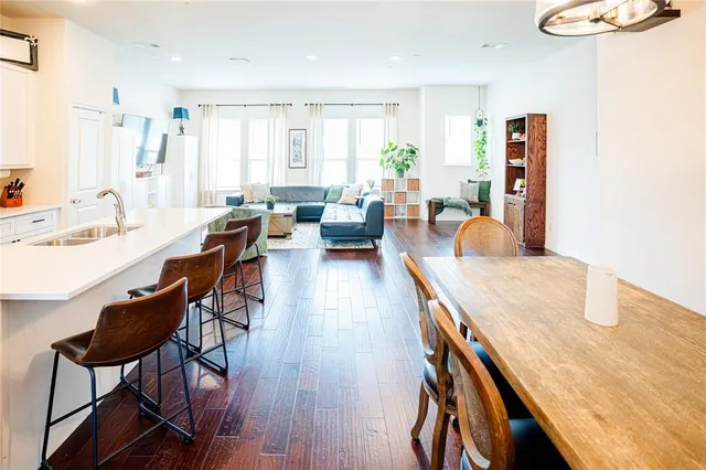 a backyard of a house with a bench and floor to ceiling window