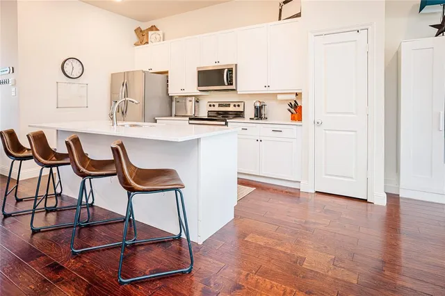 a living room with furniture a rug and white walls