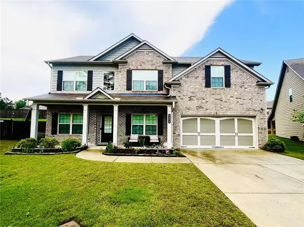 a front view of a house with a yard