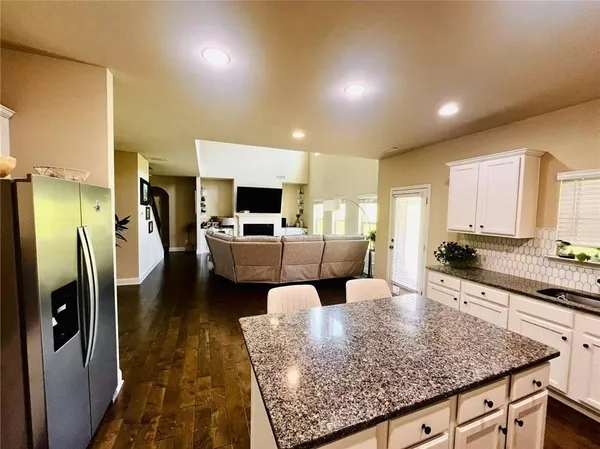 a large kitchen with stainless steel appliances granite countertop a lot of counter space