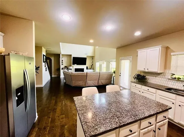 a large kitchen with stainless steel appliances granite countertop a lot of counter space