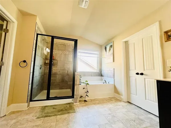 a view of a bathroom with tub and shower
