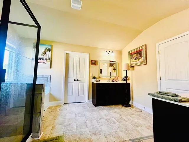 a living room with a couch and a dresser next to a window