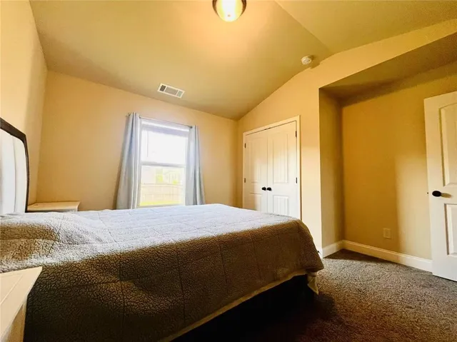 a bedroom with a bed and cabinets