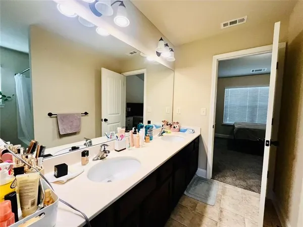 a bathroom with a sink double vanity and a mirror