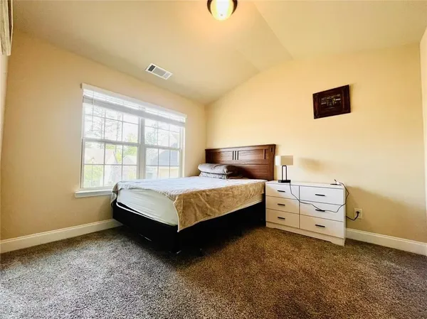 a bedroom with a bed and cabinets