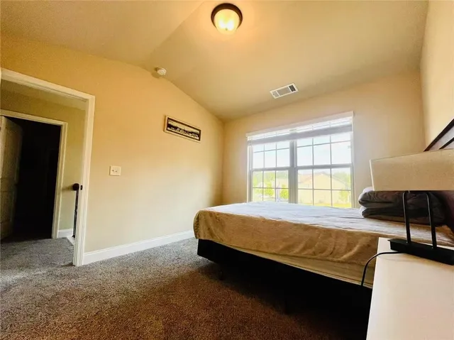 a bedroom with a bed and a table