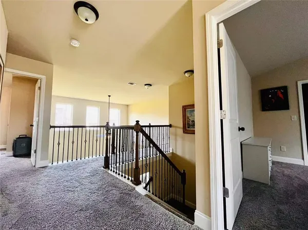 a view of a hallway to a livingroom with furniture