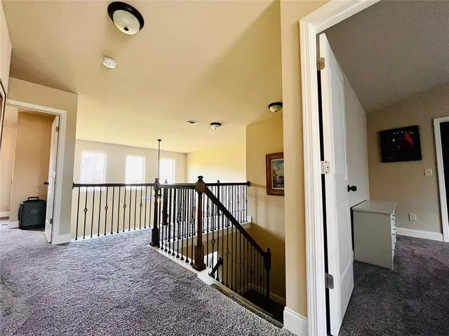 a view of a hallway to a livingroom with furniture