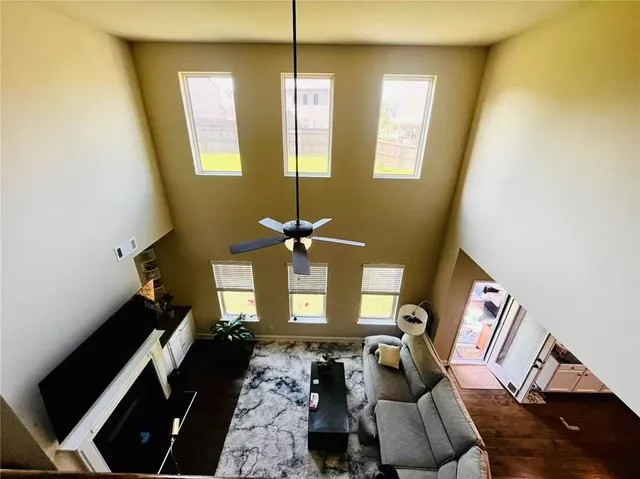 a living room with furniture and a chandelier