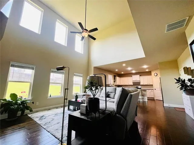 a living room with furniture and wooden floor