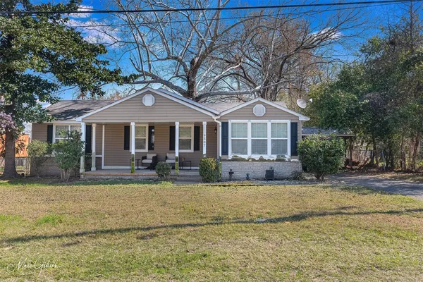 a front view of a house with swimming pool and porch