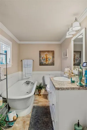 a spacious bathroom with a tub sink and mirror