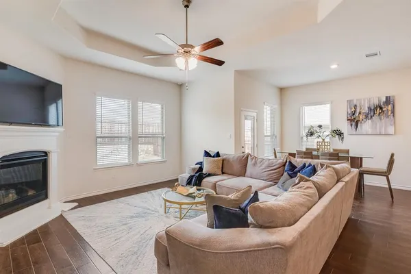 a living room with furniture a flat screen tv and a fireplace