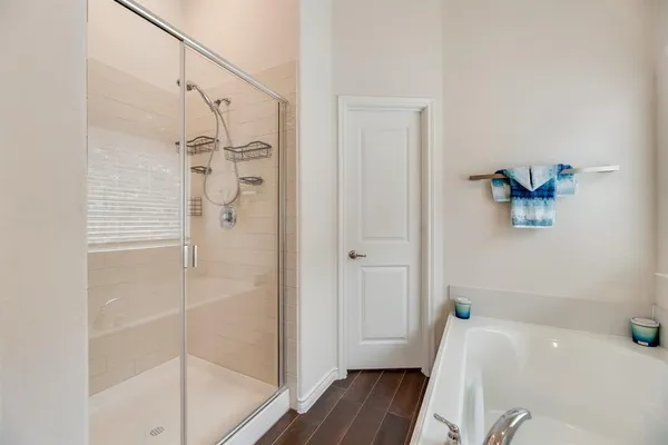 a bathroom with a bathtub and a shower